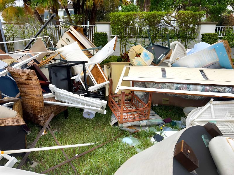 A pile of damaged furniture after a disaster.
