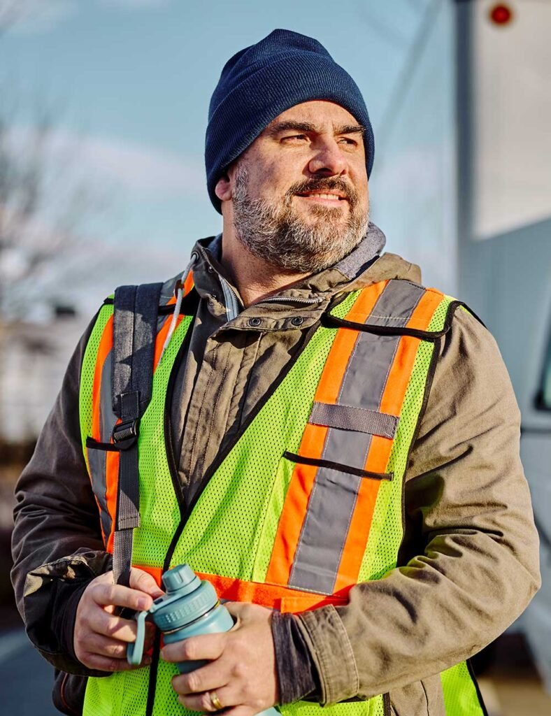 happy-truck-driver-with-backpack-and-water-bottle